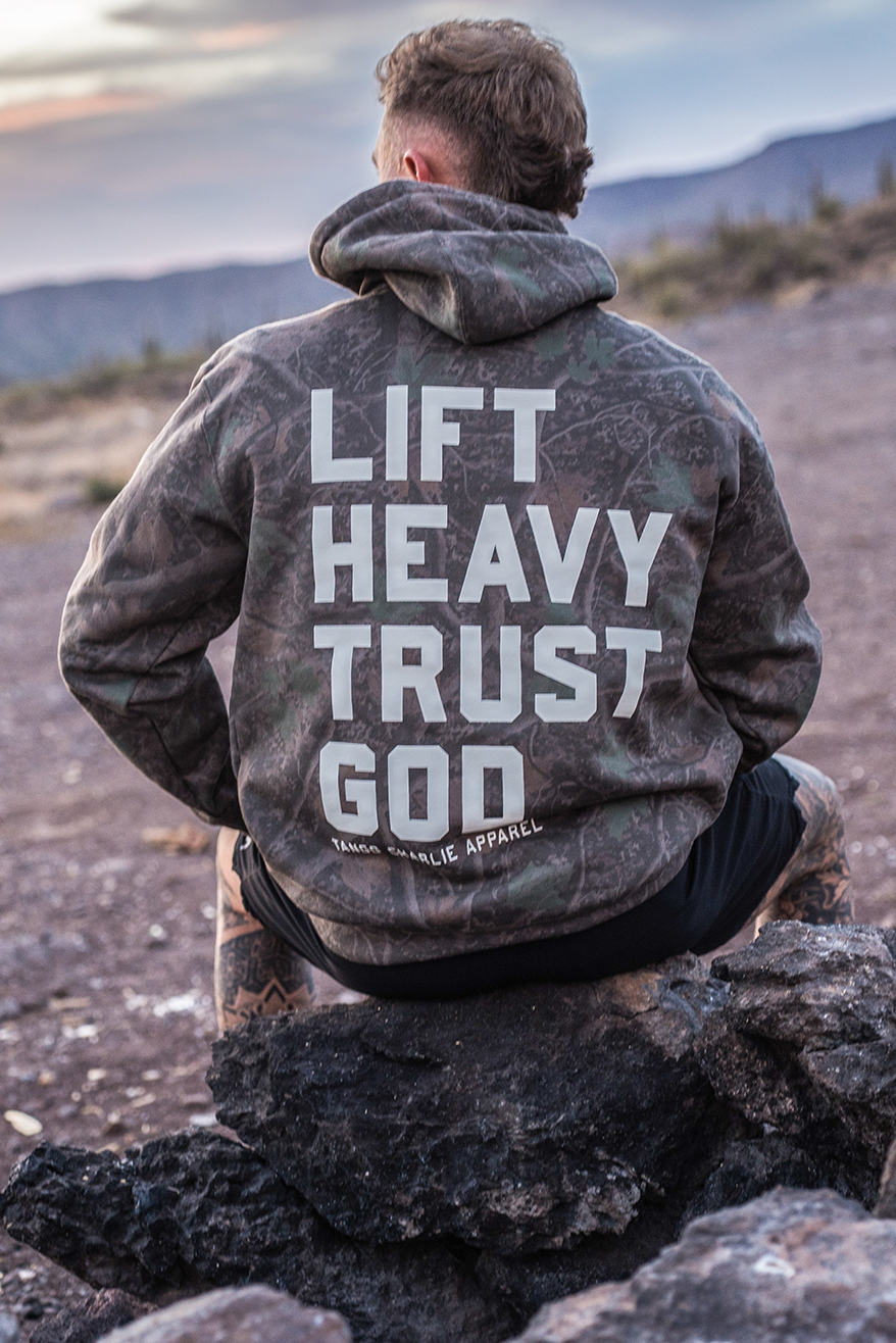 Lift Heavy. Trust God. - Premium Darkwood Camo Hoodie